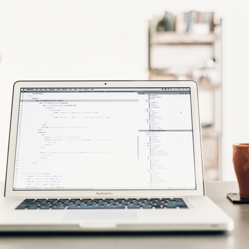 Laptop on desk with coffee cup