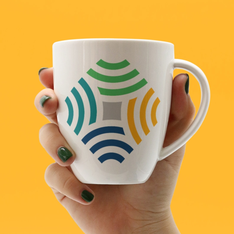 hand holding mug with AQSG logo