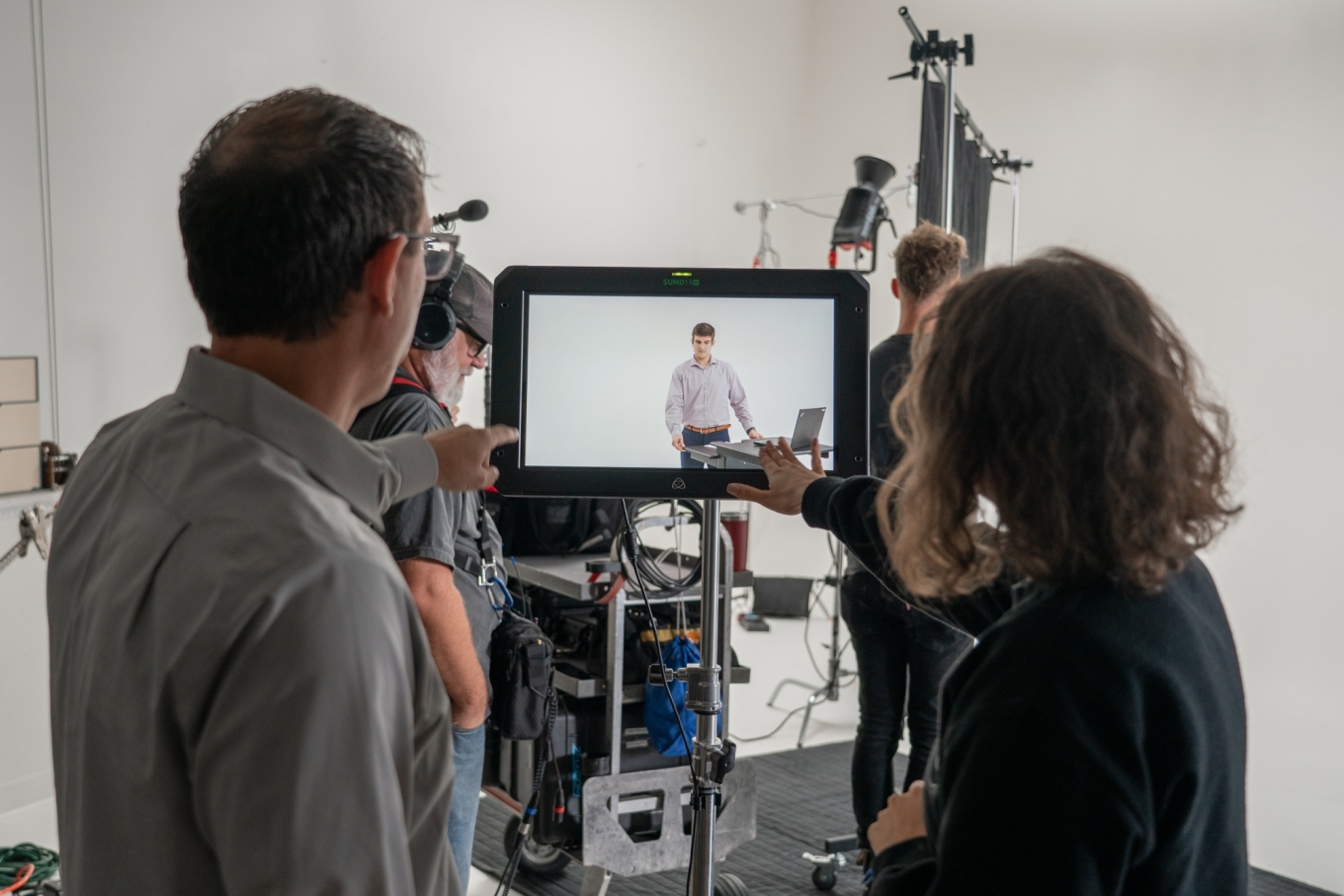 Man and woman pointing at screen