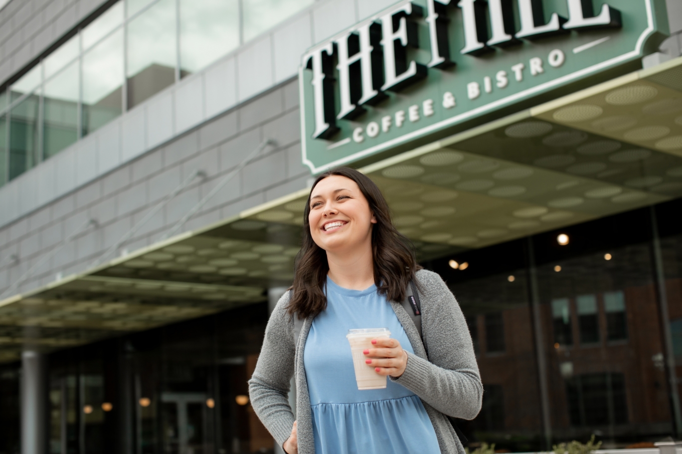 Woman smiling leaving coffee shop