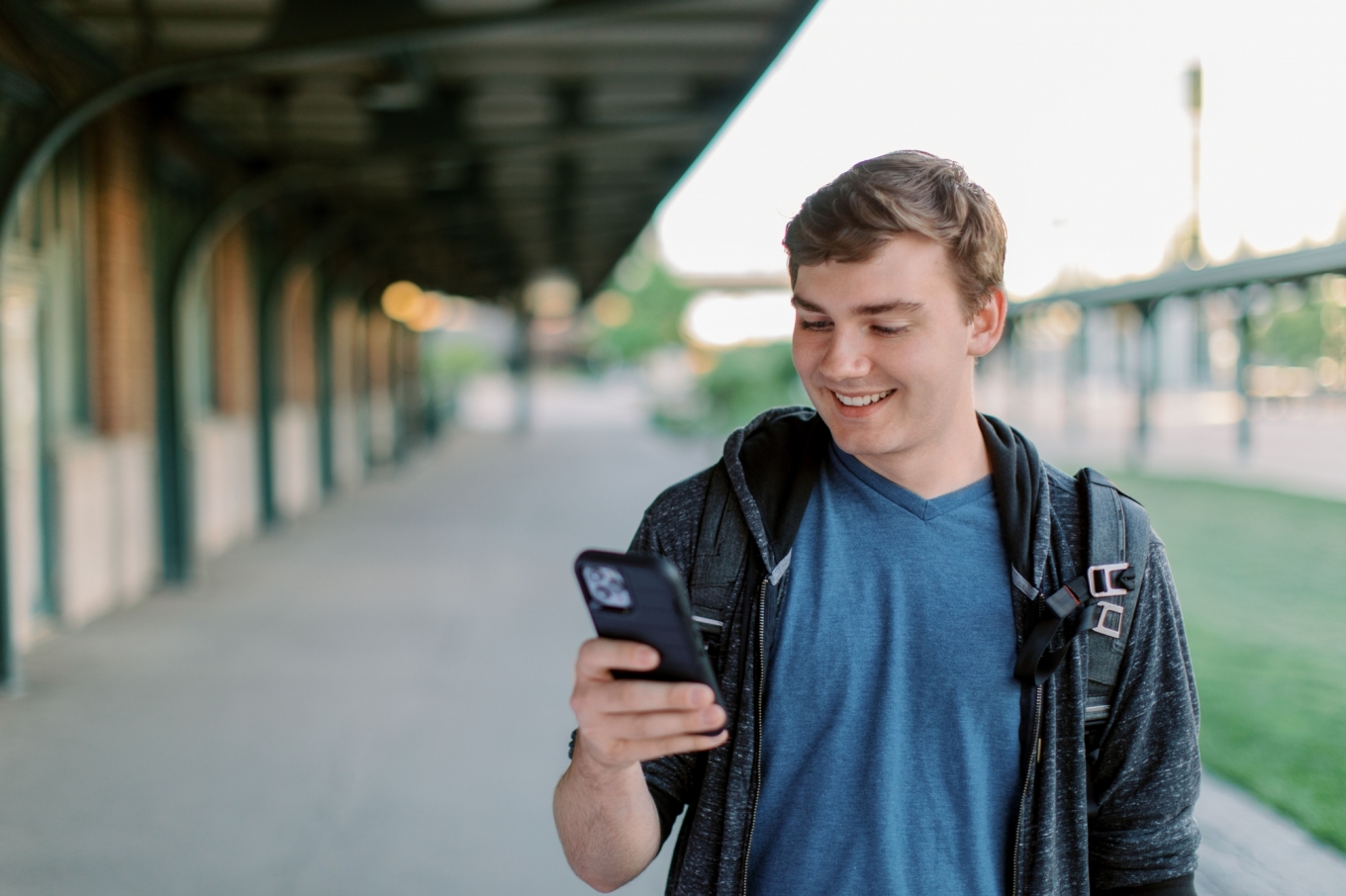 Man smiling at his phone