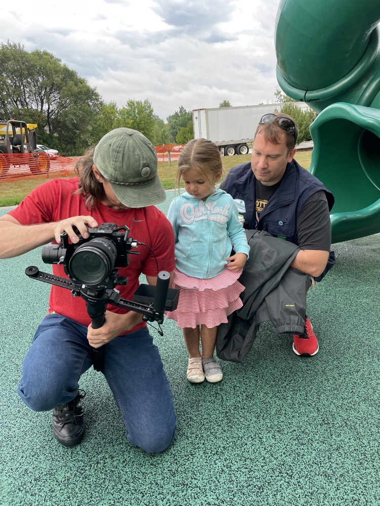 video camera with family on playground