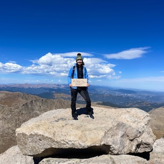 Tina on top of a mountain 